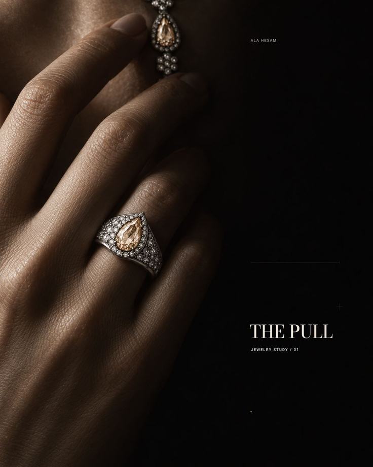 The Pull jewelry study: a ring and earring held in shadow